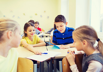 Image showing group of school kids writing test in classroom