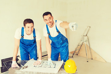 Image showing group of builders with blueprint