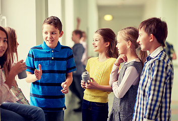 Image showing group of school kids with soda cans in corridor