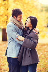 Image showing smiling couple hugging in autumn park