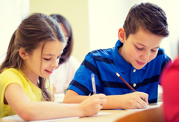 Image showing group of school kids writing test in classroom