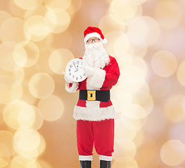 Image showing man in costume of santa claus with clock