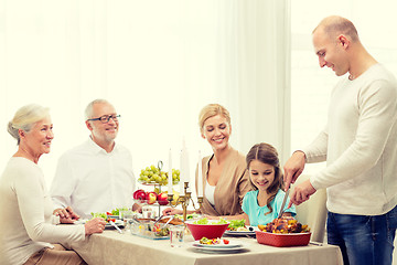 Image showing smiling family having holiday dinner at home