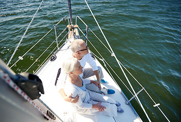 Image showing senior couple hugging on sail boat or yacht in sea