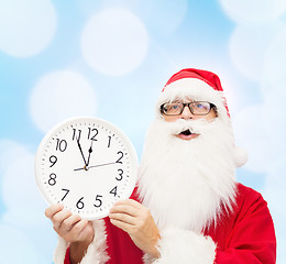 Image showing man in costume of santa claus with clock