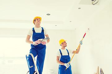 Image showing group of builders with tools indoors