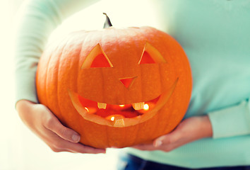 Image showing close up of woman with pumpkins at home