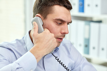 Image showing face of businessman calling on phone in office