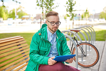 Image showing happy young hipster man with tablet pc and bike