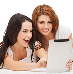 Image showing two smiling teenage girls with tablet pc computer