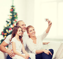 Image showing happy family with camera at home