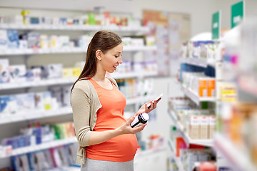 Image showing happy pregnant woman with smartphone at pharmacy