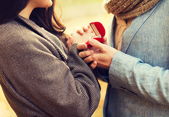 Image showing close up of couple with gift box in park