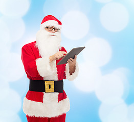 Image showing man in costume of santa claus with tablet pc