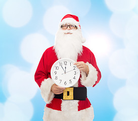 Image showing man in costume of santa claus with clock