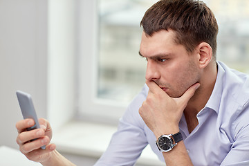 Image showing close up of businessman with smartphone