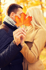 Image showing close up of couple kissing in autumn park