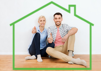 Image showing happy couple showing thumbs up at new home