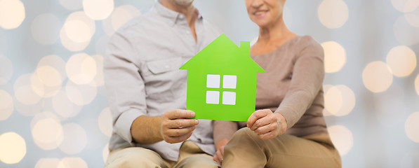 Image showing close up of happy senior couple with green house