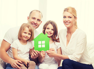 Image showing smiling parents and two little girls at new home