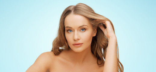 Image showing beautiful young woman face over blue background