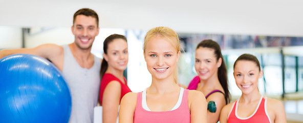 Image showing woman standing in front of the group in gym