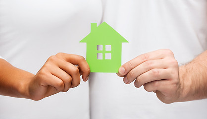 Image showing couple hands holding green house