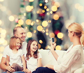 Image showing happy family with camera at home