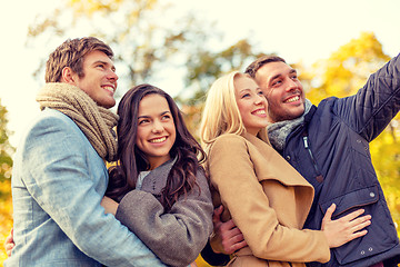 Image showing group of smiling men and women in autumn park