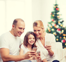 Image showing happy family with smartphones