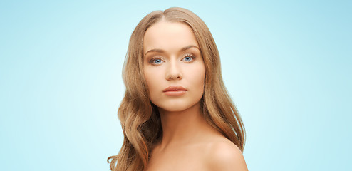 Image showing beautiful young woman face over blue background