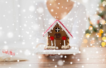 Image showing close up of woman showing gingerbread house