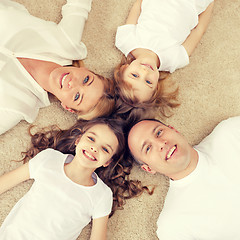 Image showing parents and two girls lying on floor at home