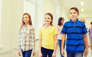 Image showing group of smiling school kids walking in corridor