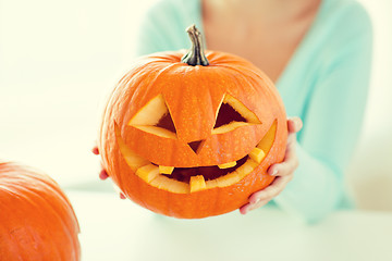 Image showing close up of woman with pumpkins at home