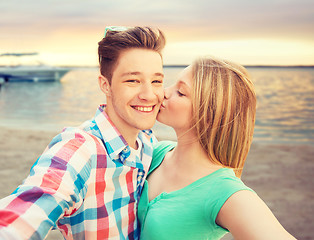 Image showing happy couple taking selfie on summer beach