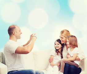 Image showing happy family with camera at home