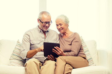 Image showing happy senior couple with tablet pc at home