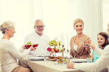 Image showing smiling family having holiday dinner at home