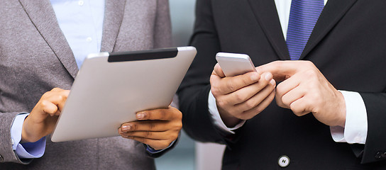 Image showing two businesspeople with smartphone and tablet pc