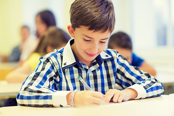 Image showing group of school kids writing test in classroom