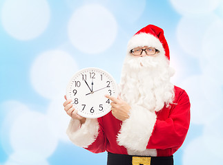 Image showing man in costume of santa claus with clock