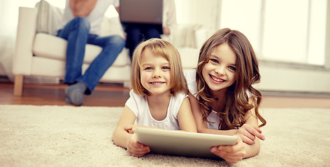 Image showing happy little girls with tablet pc computer at home