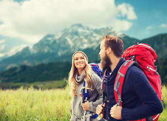 Image showing smiling couple with backpacks hiking