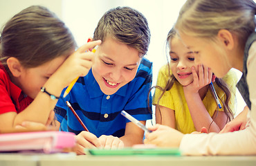 Image showing group of students talking and writing at school