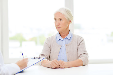 Image showing doctor with clipboard and senior woman at hospital