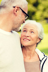 Image showing senior couple hugging in city park