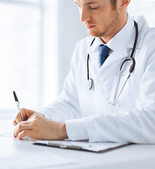 Image showing patient and doctor taking notes