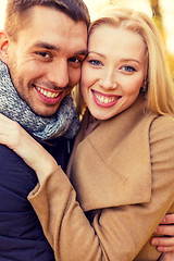 Image showing smiling couple hugging in autumn park