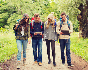 Image showing group of friends with backpacks and tablet pc